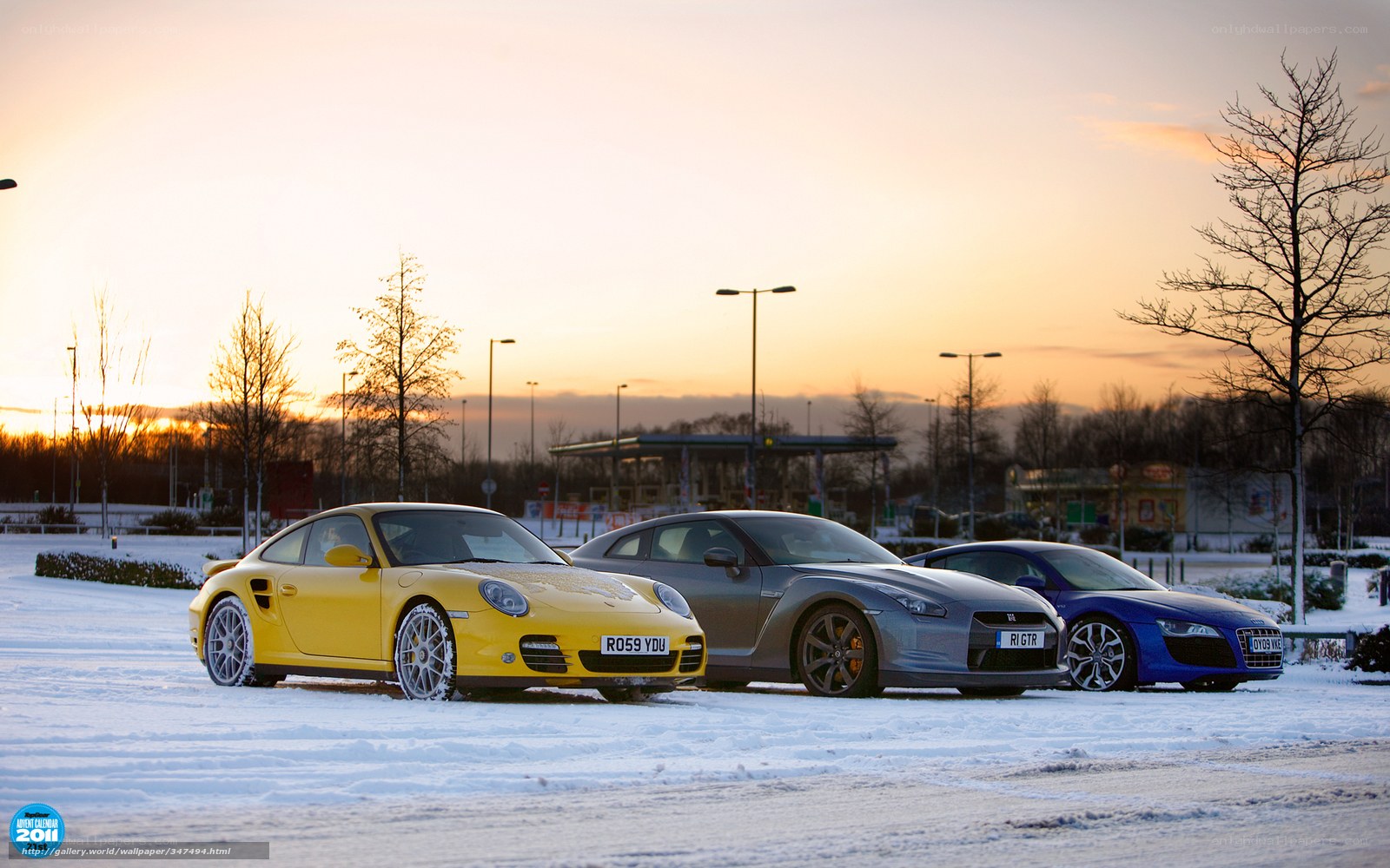 sports cars in snow at sunset