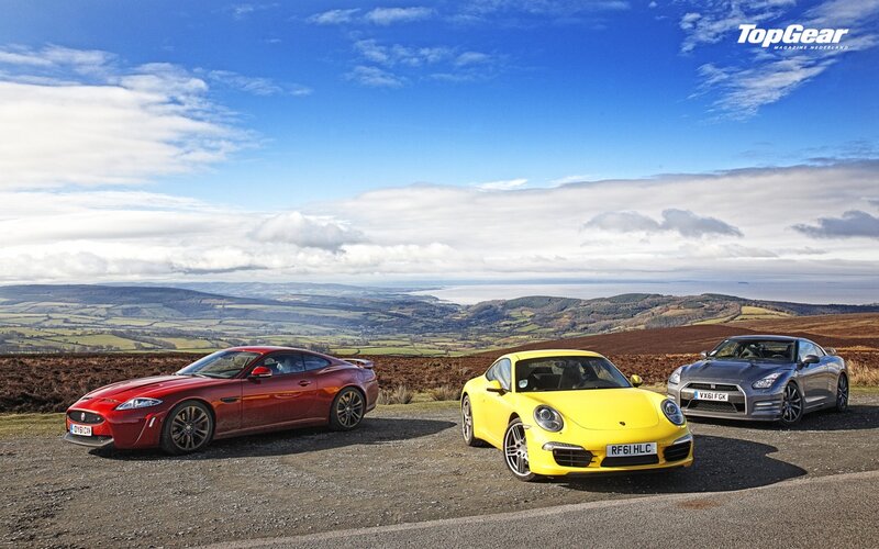 sports cars on a scenic overlook