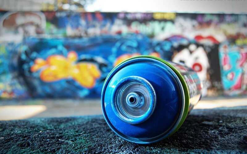 spray can in front of graffiti