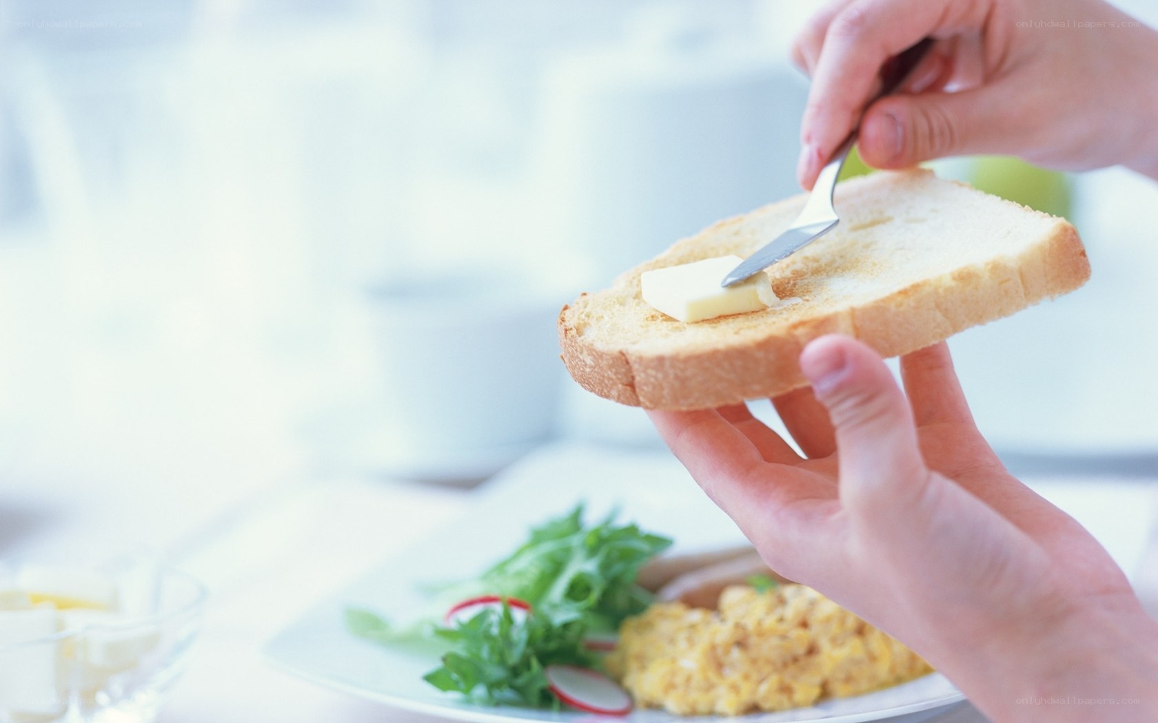 spreading butter on toast