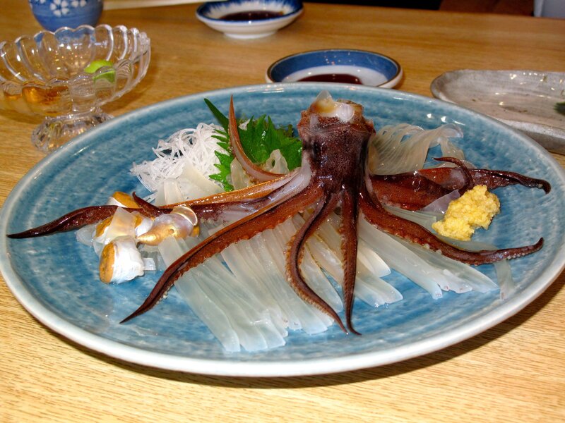 Squid sashimi on a blue plate