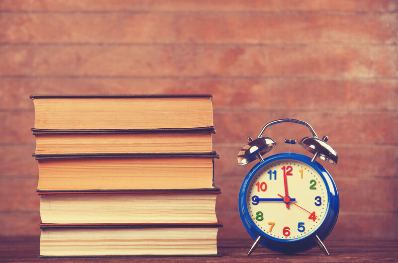 Stack of Books and Alarm Clock