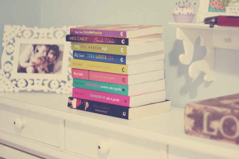 stack of books on a dresser