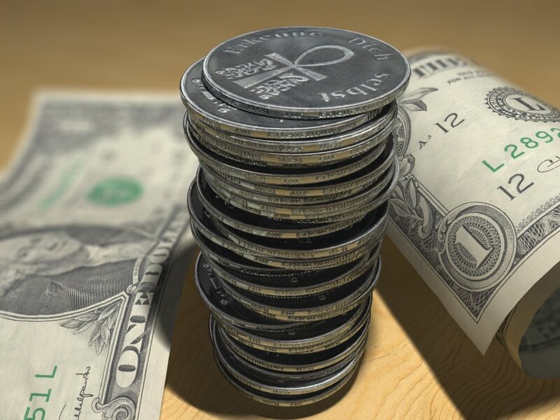 stack of coins with dollar bills