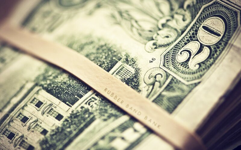 stack of dollar bills with rubber band
