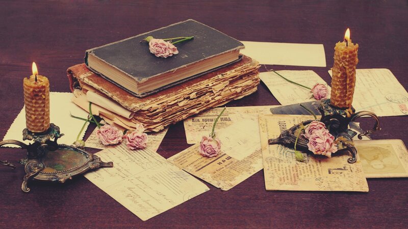 Stack of Old Books and Candles