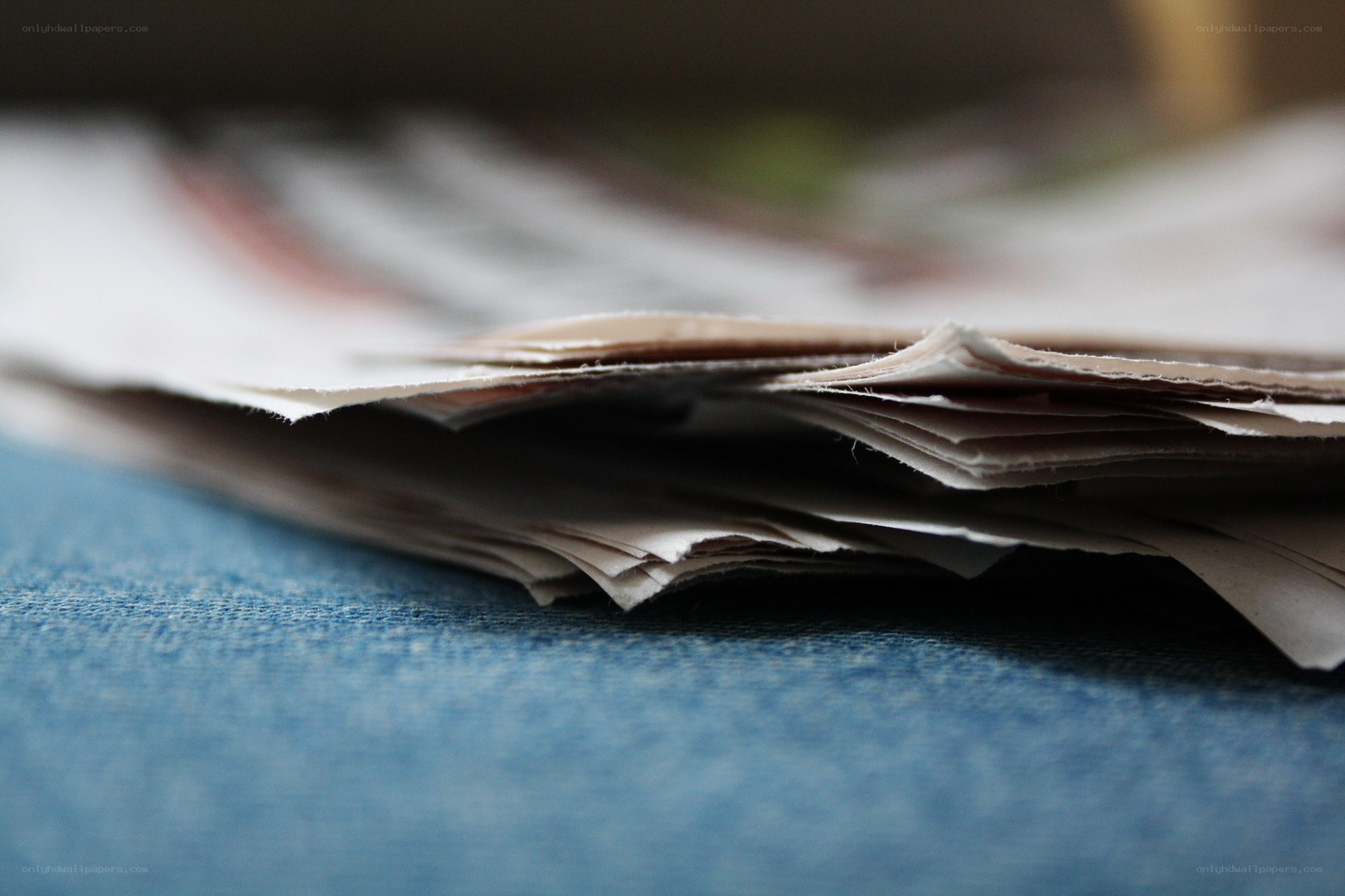 stack of papers on blue fabric