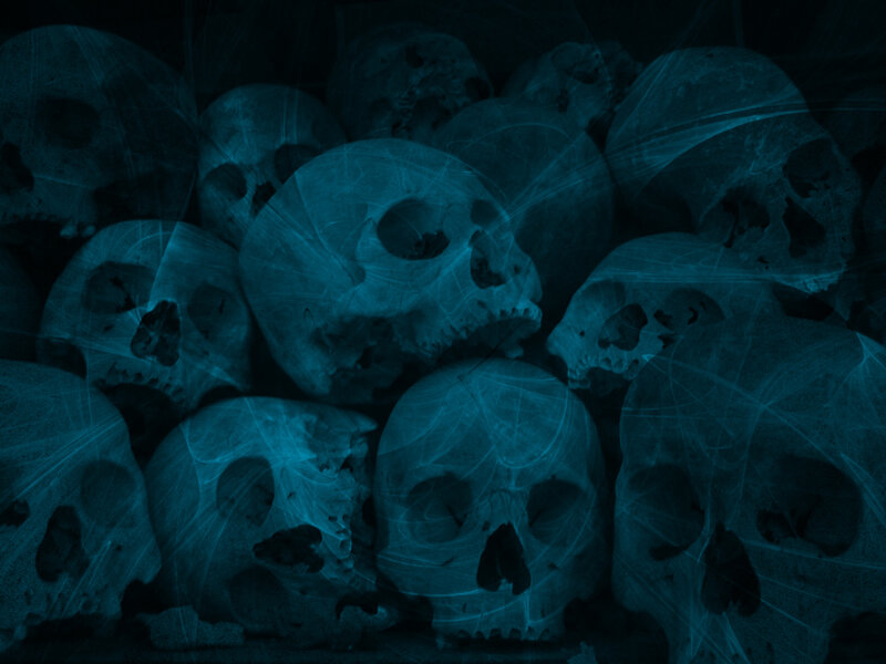stack of skulls in blue light