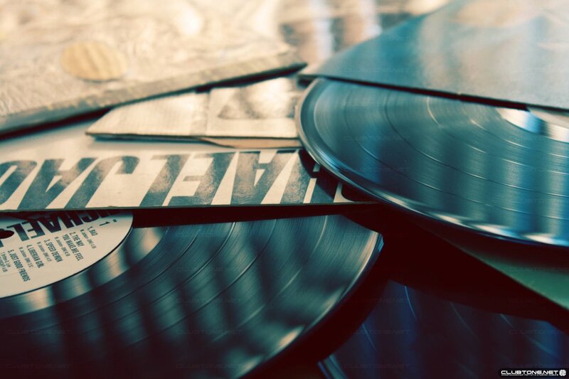 stack of vinyl records and album covers