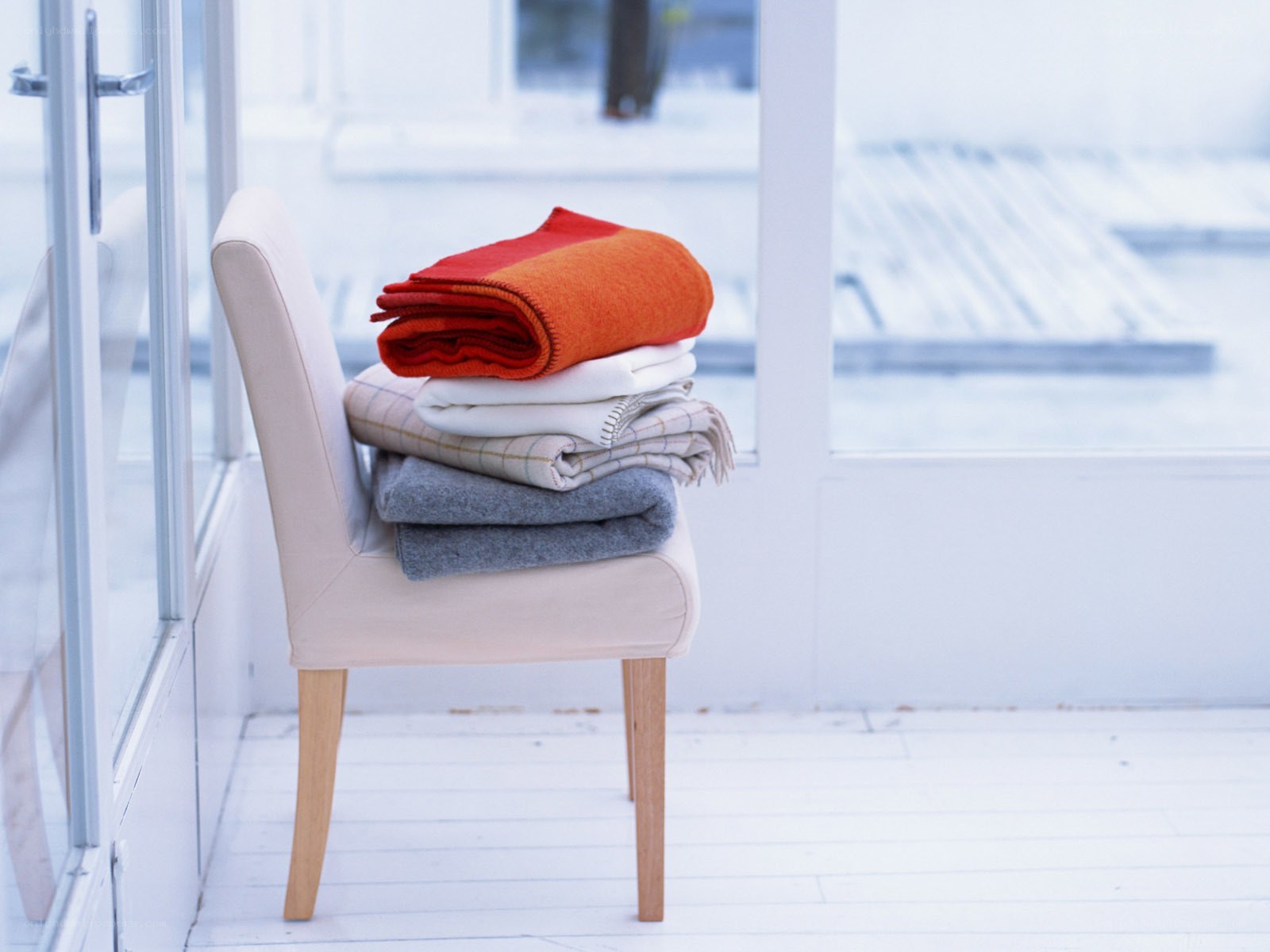 Stacked blankets on a chair