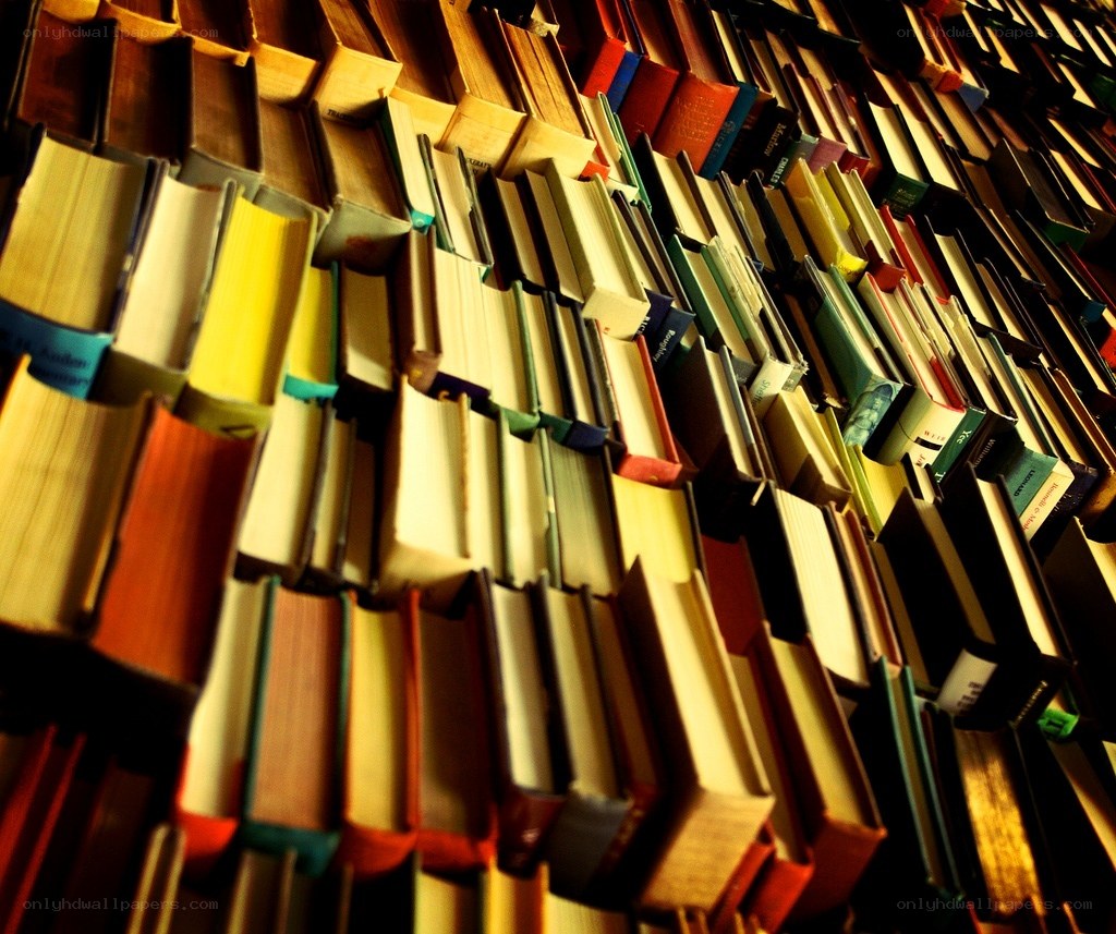 stacked books in warm light