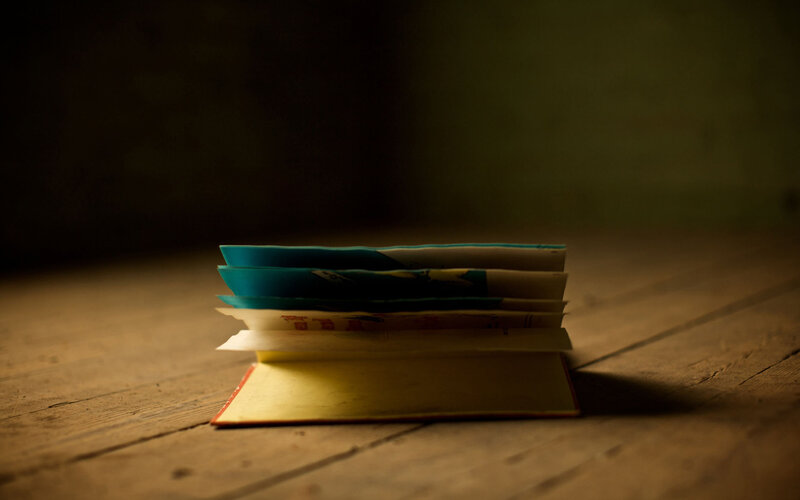 stacked books on wooden surface