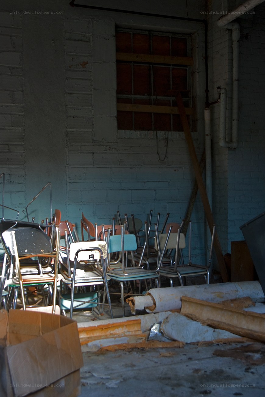 stacked chairs in storage room