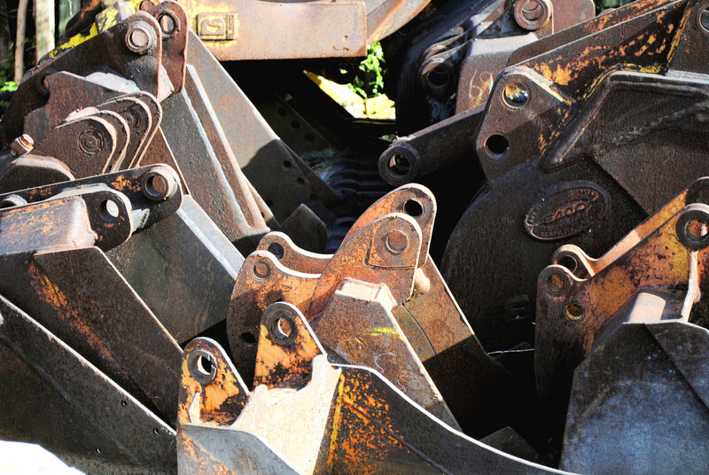 stacked excavator buckets