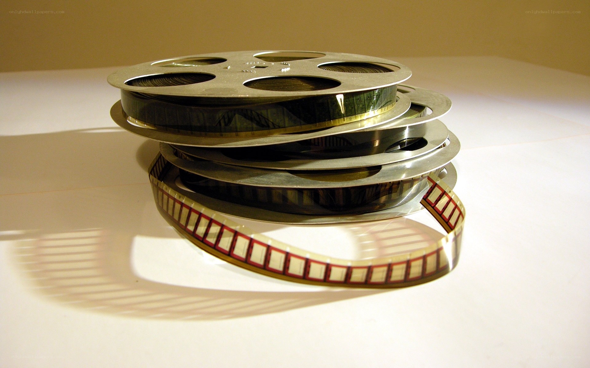 stacked film reels on white surface