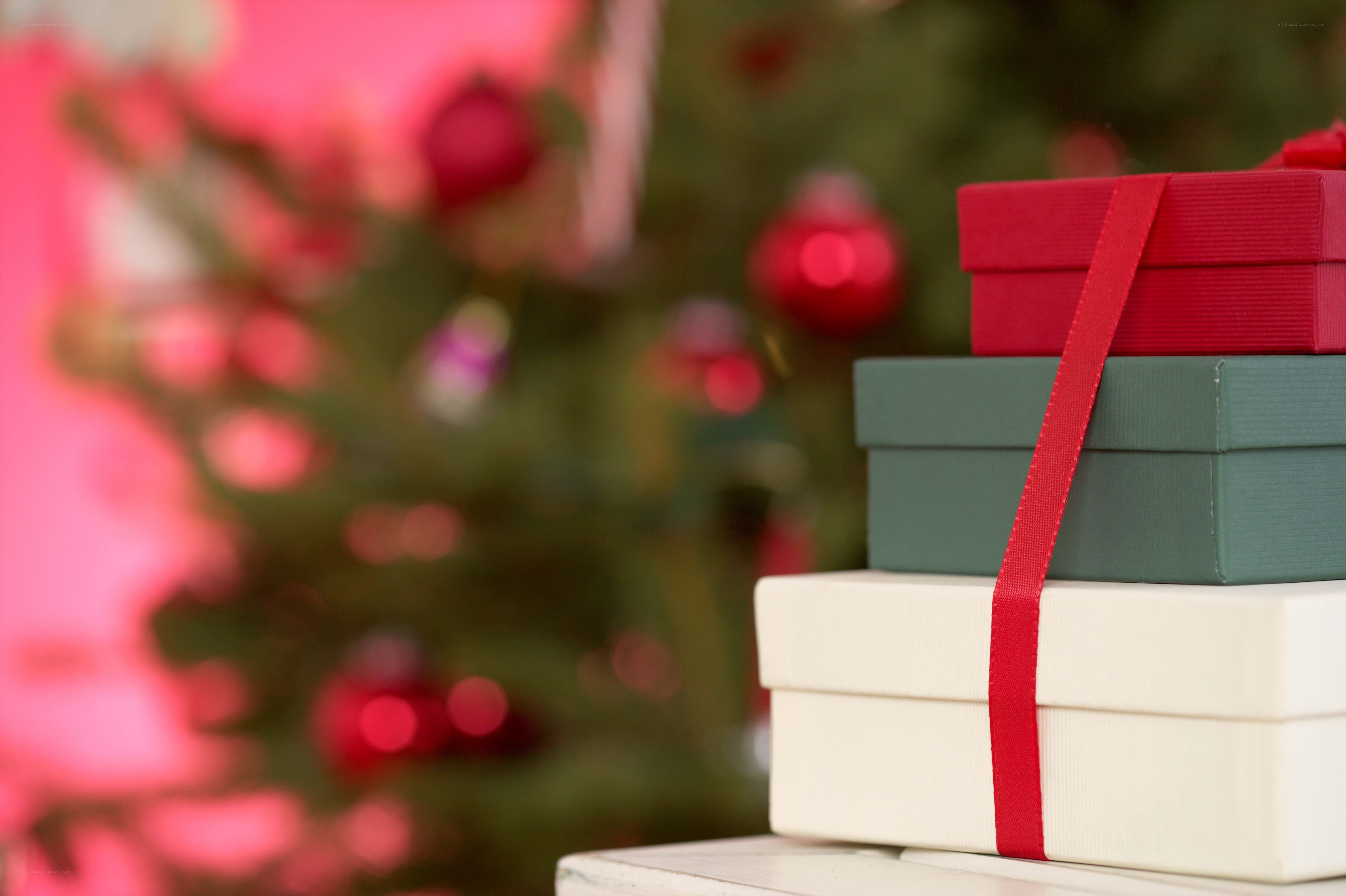 stacked gift boxes near christmas tree
