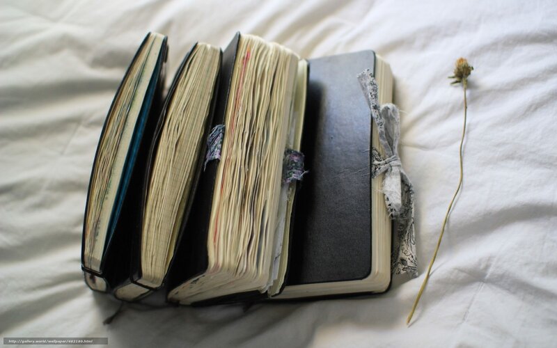 stacked journals on bed