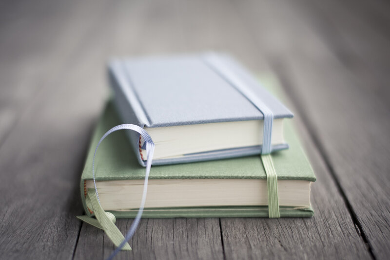 Stacked Notebooks on Wood