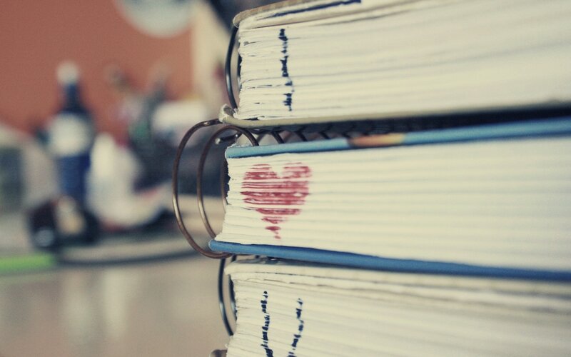 stacked notebooks with heart
