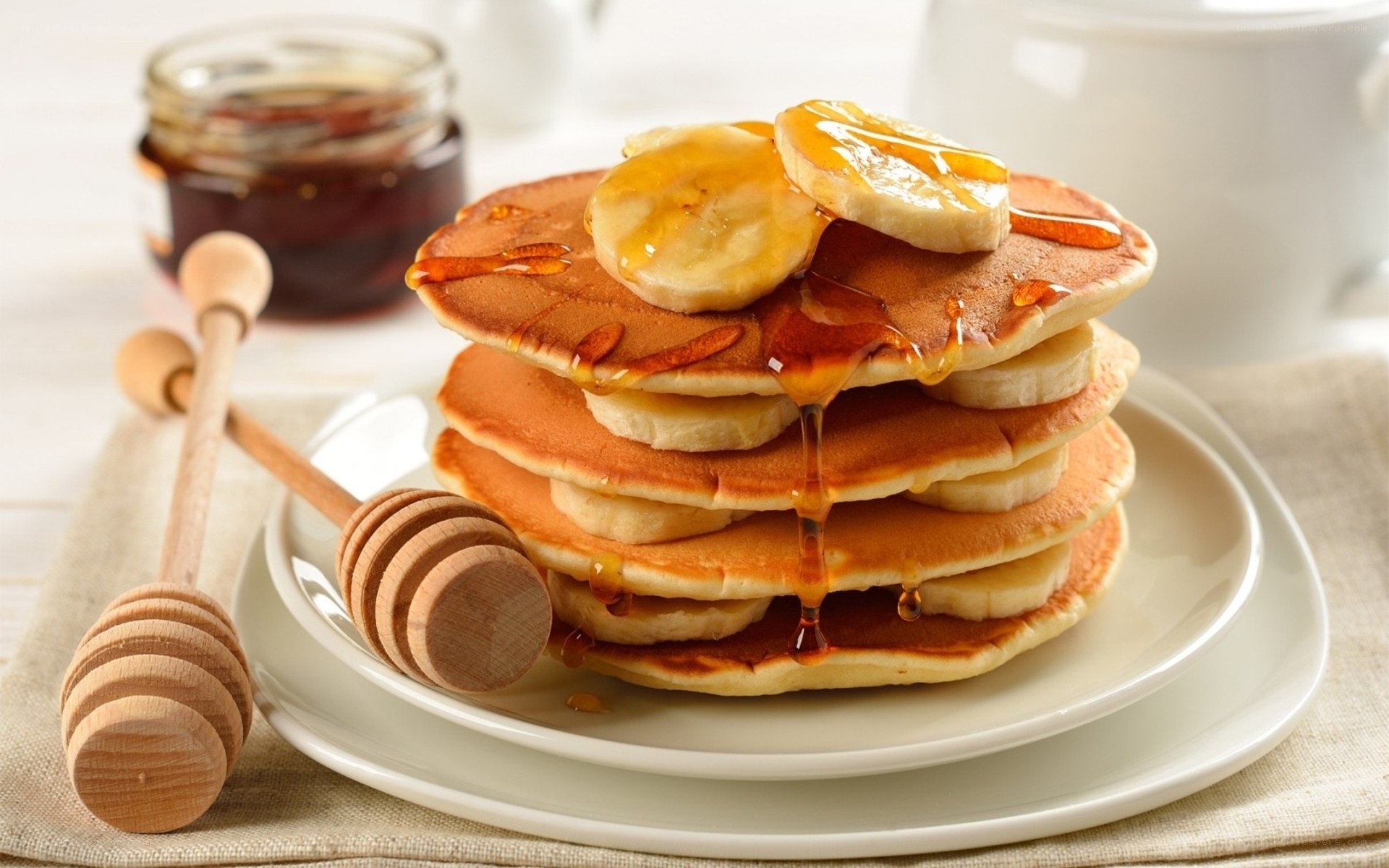 stacked pancakes with bananas
