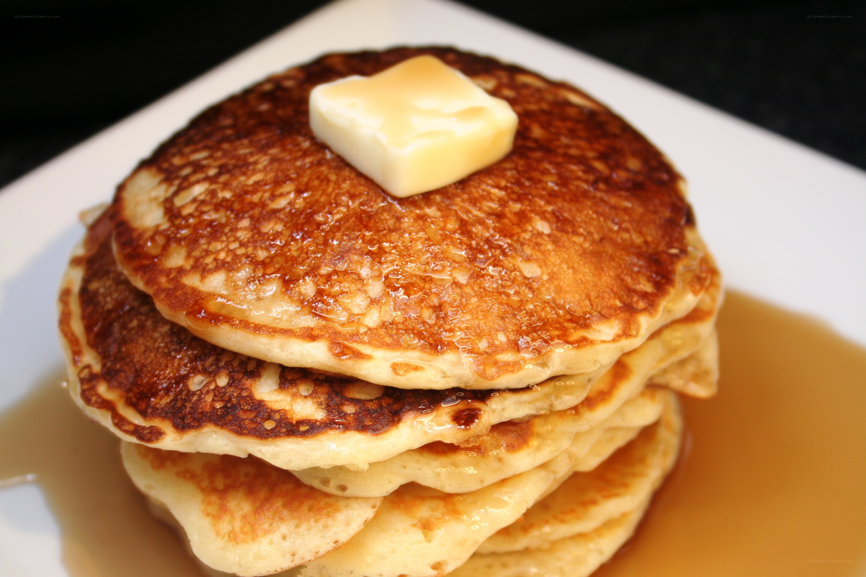 stacked pancakes with butter