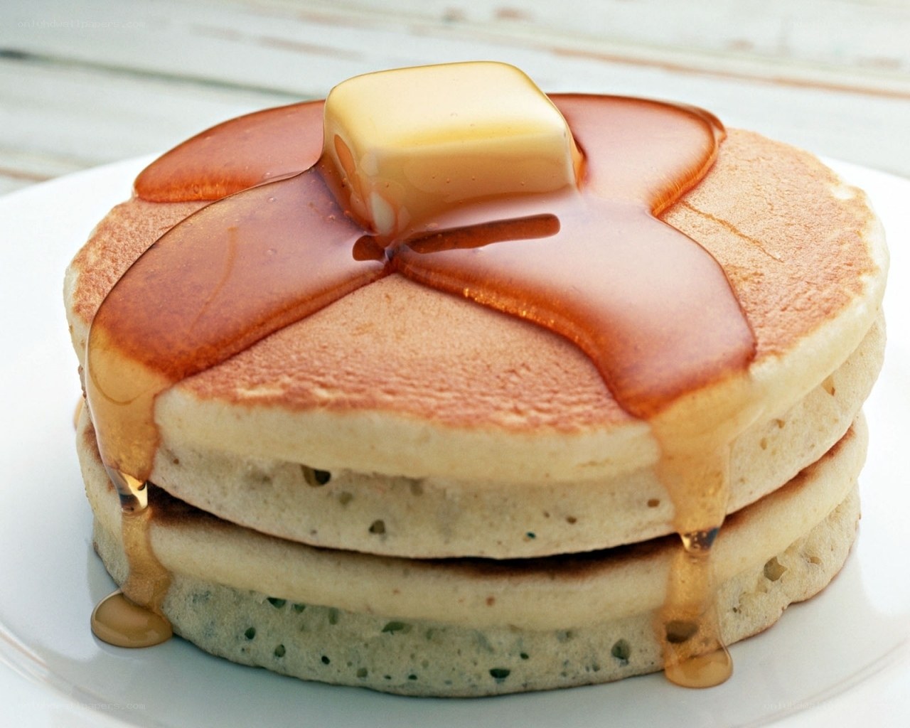 stacked pancakes with butter and syrup
