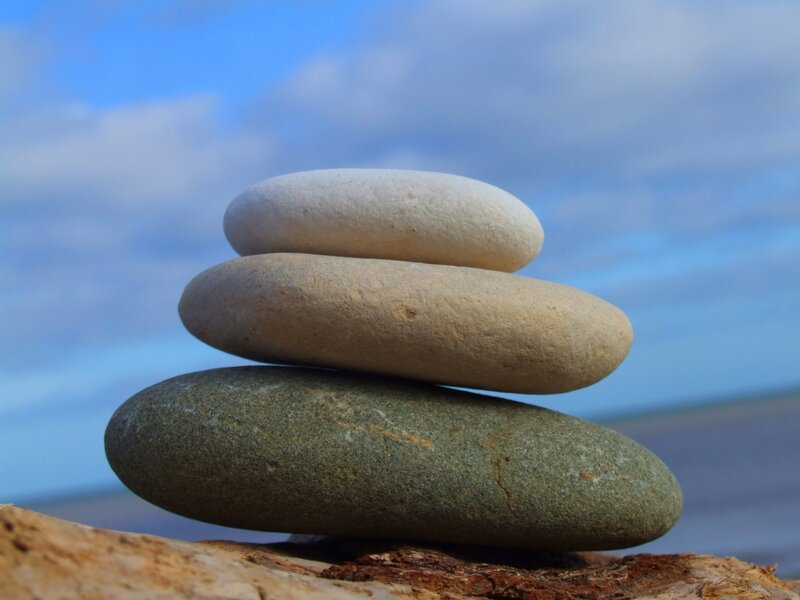 Stacked Pebbles on Driftwood
