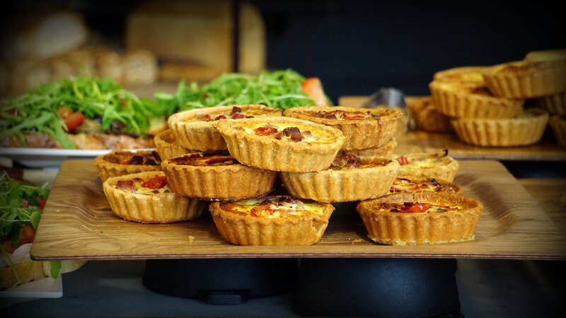 Stacked quiches on a wooden board