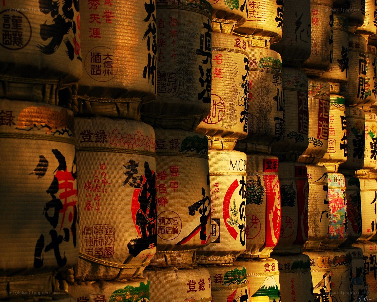 Stacked sake barrels at night