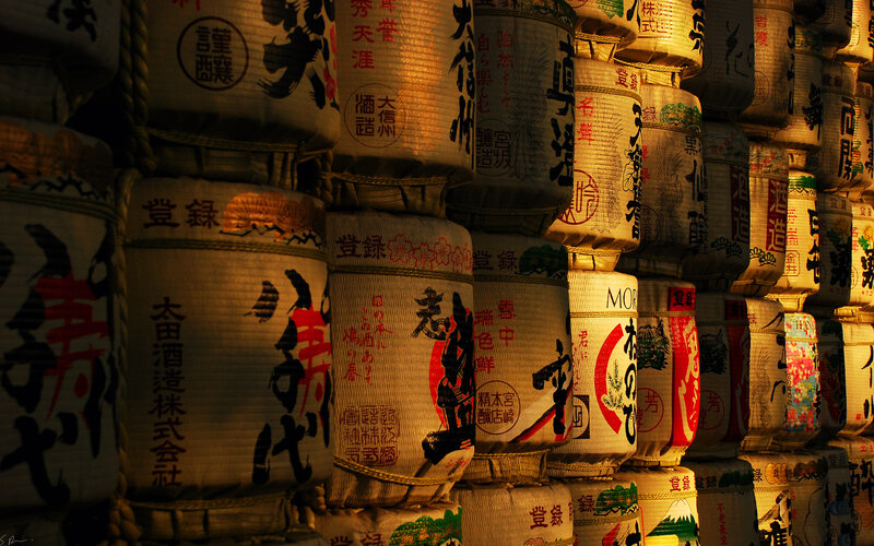 stacked sake barrels at night