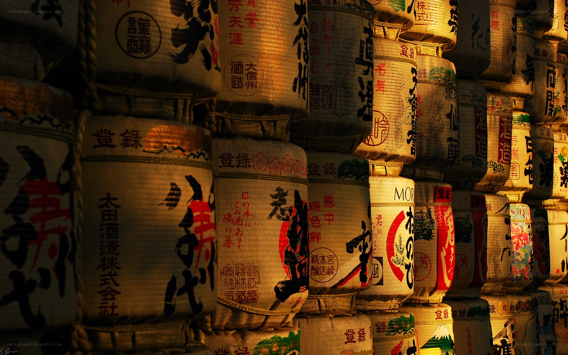 stacked sake barrels at night