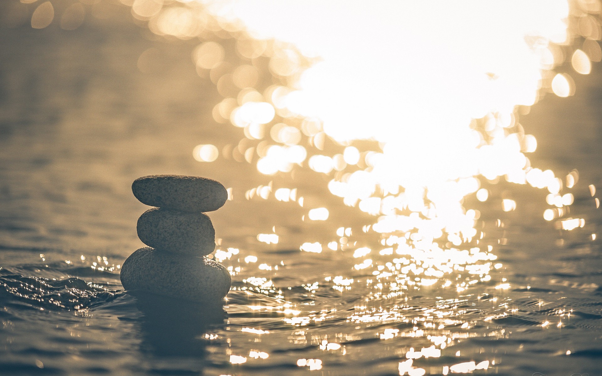 Stacked stones at sunset