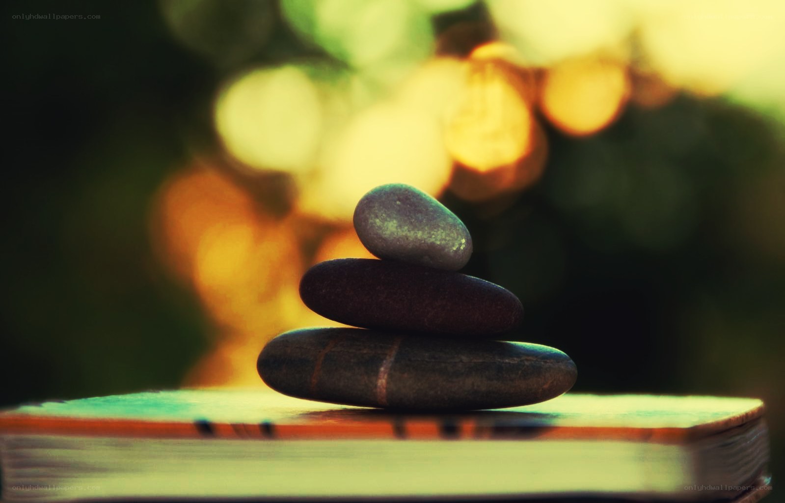 Stacked stones on a book