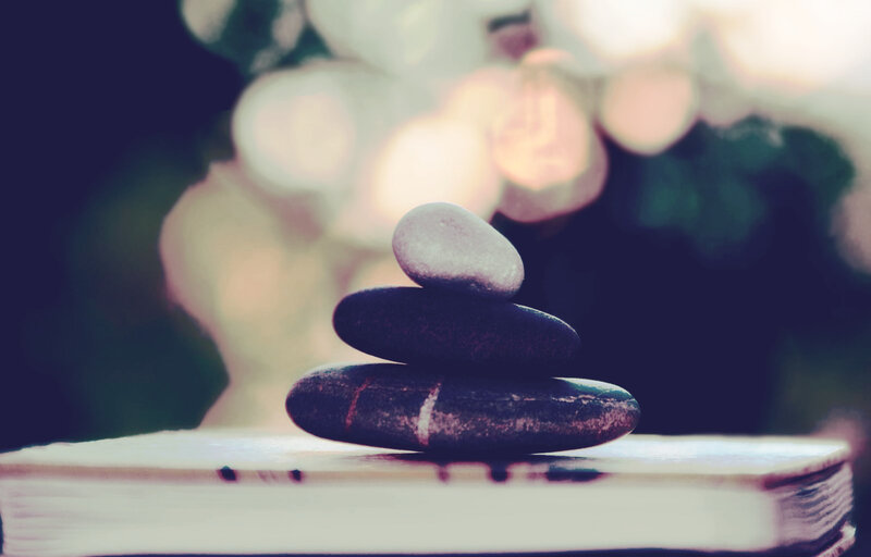 Stacked stones on a book