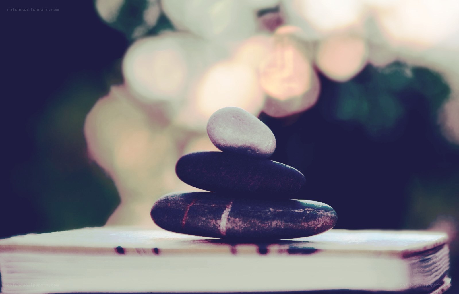 Stacked stones on a book