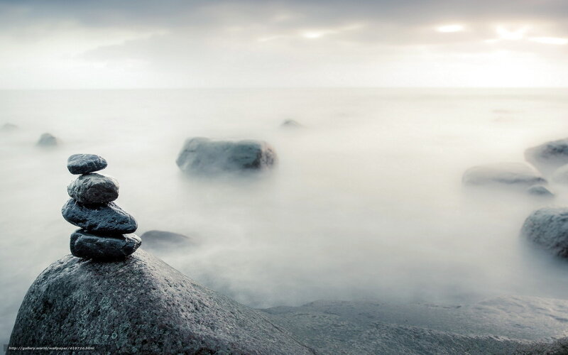 Stacked stones on a misty shore