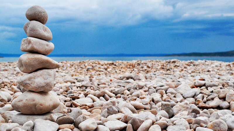 Stacked stones on a pebble beach