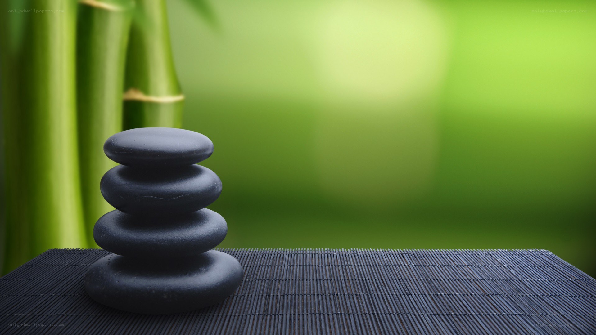 stacked stones on bamboo mat