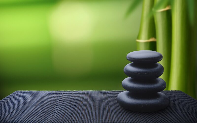Stacked stones on bamboo mat