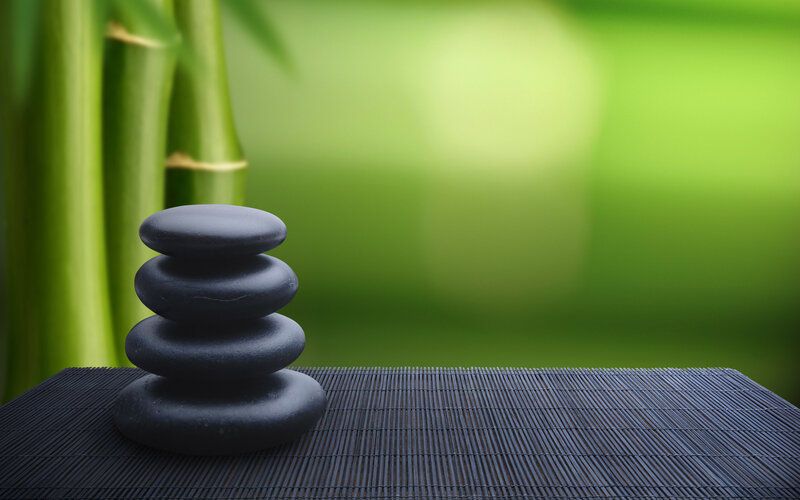Stacked stones on bamboo mat
