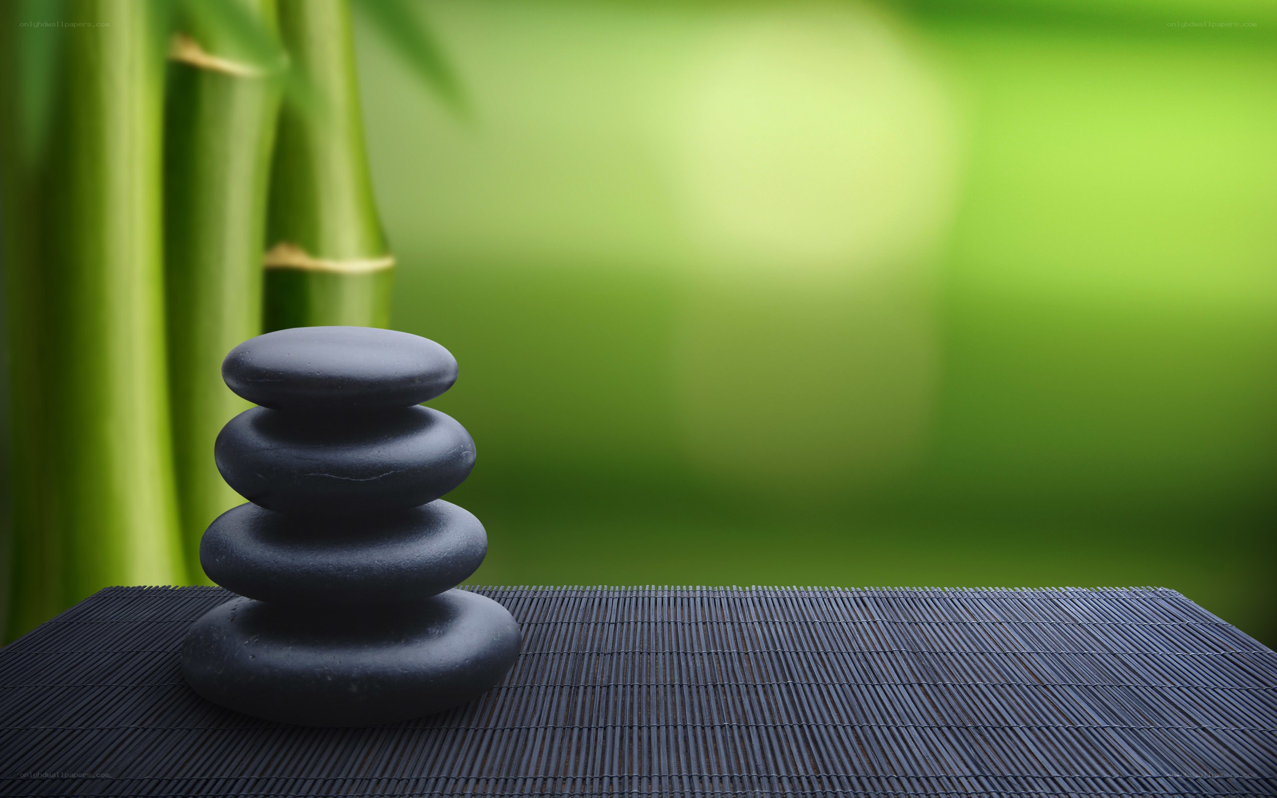 Stacked stones on bamboo mat