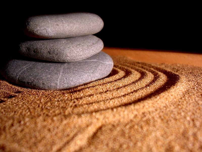 stacked stones on raked sand
