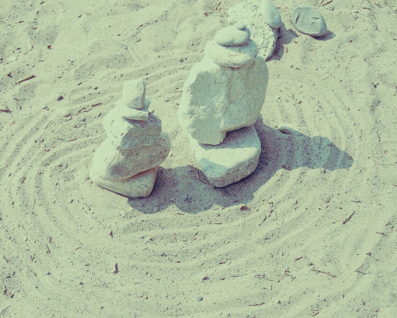 Stacked stones on sandy beach