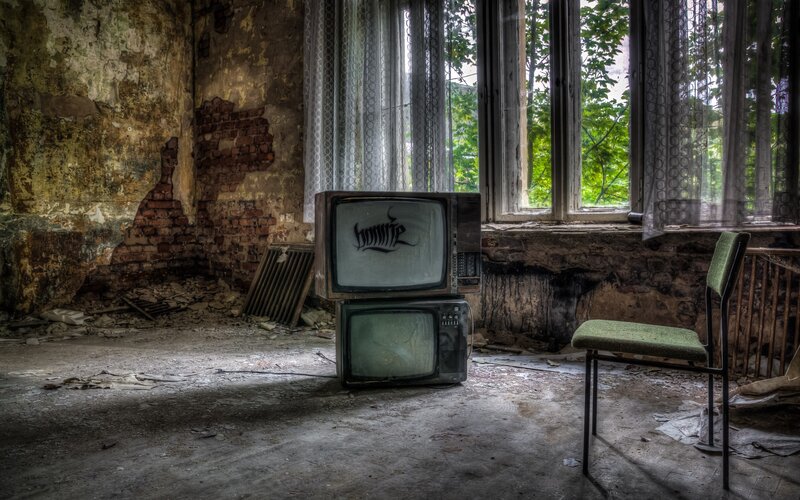 Stacked Televisions in Ruin