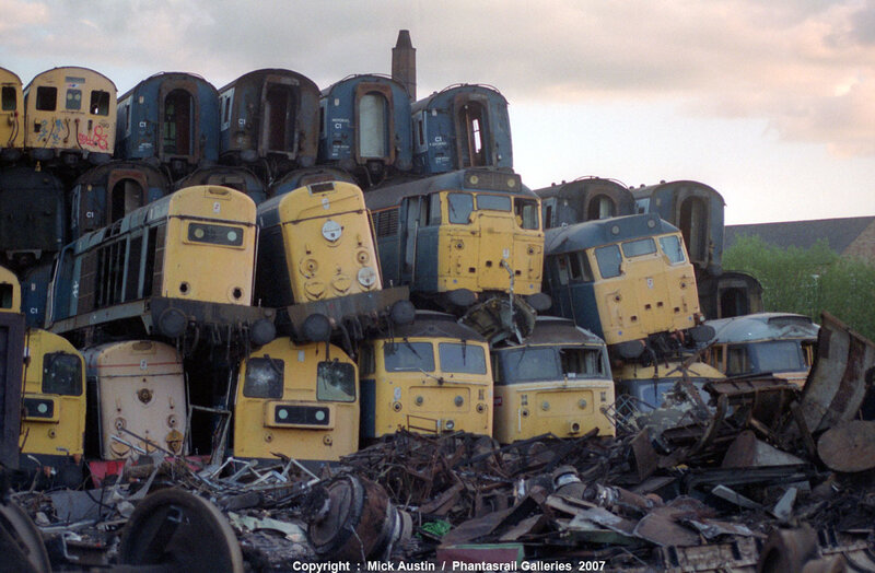 stacked train engines at scrapyard