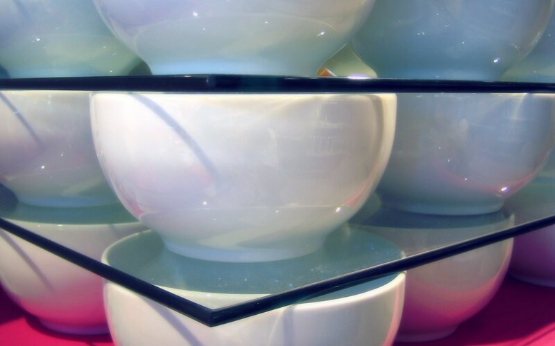 Stacked white bowls on glass shelves