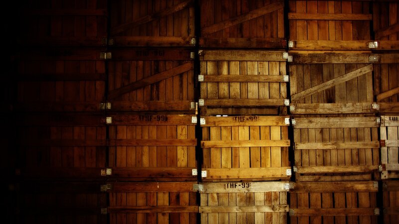 stacked wooden crates in dim light