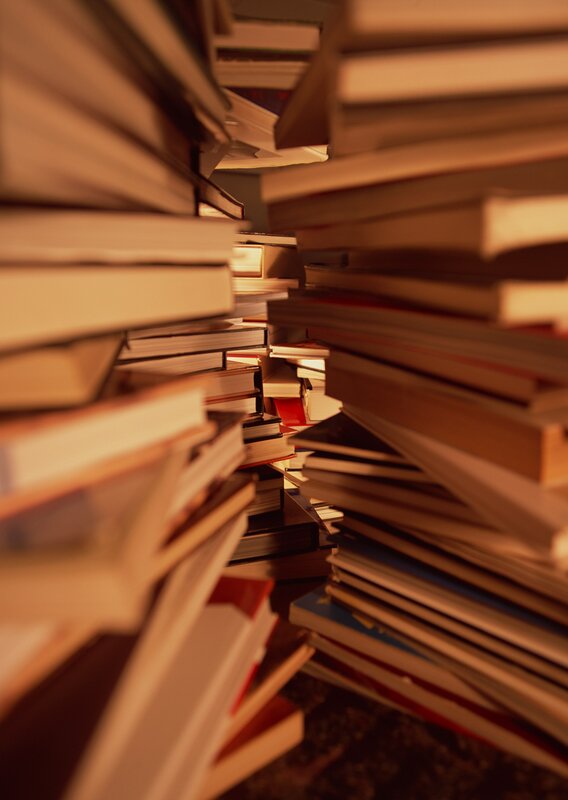 stacks of books in warm light