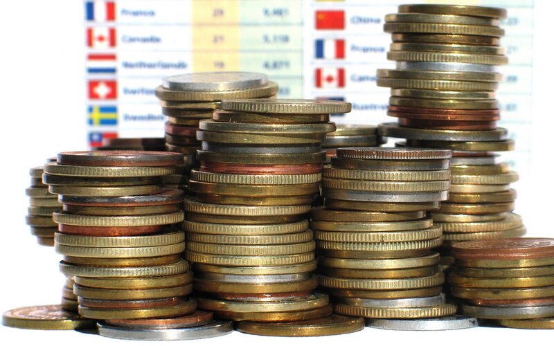 stacks of coins with country flags