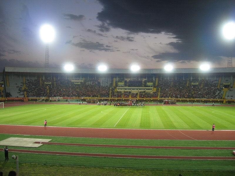 Stadium at dusk with fans